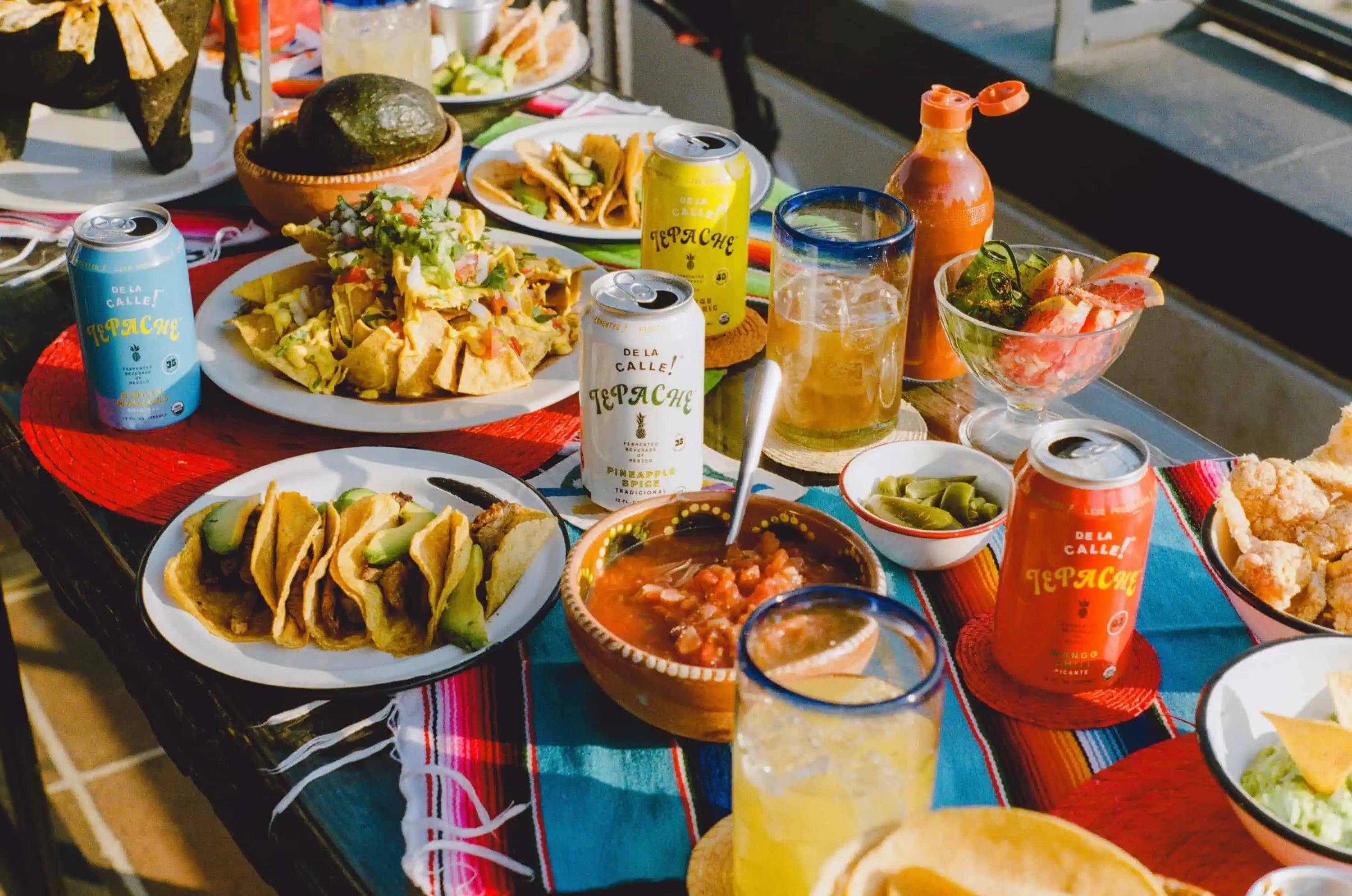 Authentic Latin American feast with tacos, nachos, fresh salsa, guacamole, and margarita cocktails, set on a vibrant outdoor dining table at Wholefood Circus in Shenton Park. A one-night-only event celebrating Mexican, Colombian, Argentinian, and Peruvian cuisine.